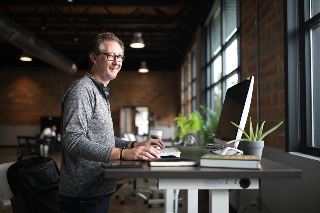 IT professional typing in the laptop while standing
